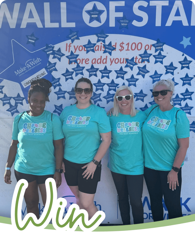 4 women standing next to eachother in front of a backdrop that says wall of stars from a charity event, the word win in green script font below