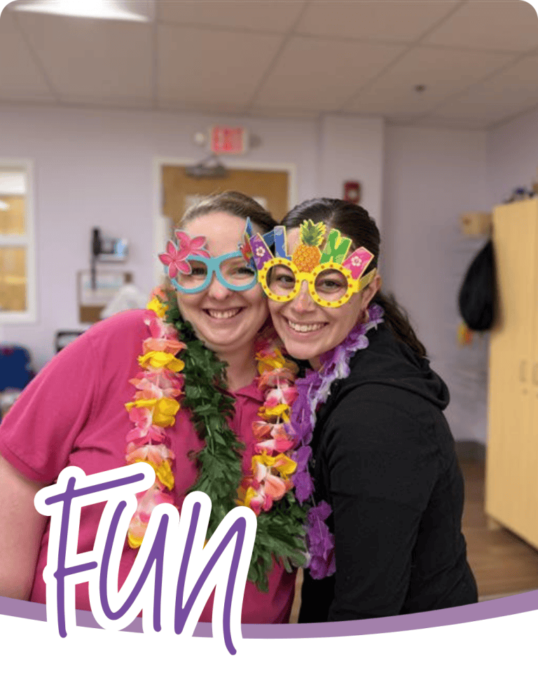 image of two people in festive glasses and flower necklaces with the word fun in purple script font below