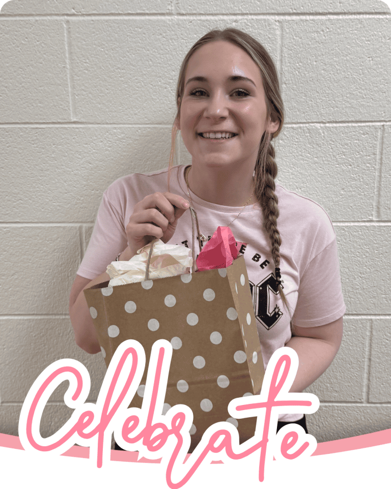image of a woman smiling and holding up a gift bag with the word celebrate in pink script font below